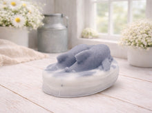 Load image into Gallery viewer, A handmade vegan soap featuring two grey dolphins jumping through white frothy waves; the base is white, and the dolphins are highly detailed, displayed on a light wooden surface against a soft farmhouse background.