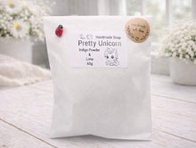 Load image into Gallery viewer, Handmade soap packaging with 'Pretty Unicorn' branding on a light wooden surface.