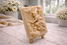 Load image into Gallery viewer, handmade vegan soap bar featuring a detailed relief carving of a witch flying on a broomstick past a crescent moon, owls, and pumpkins.