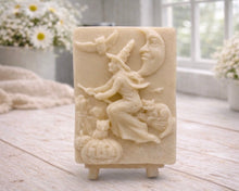 Load image into Gallery viewer, handmade vegan soap bar featuring a detailed relief carving of a witch flying on a broomstick past a crescent moon, owls, and pumpkins.