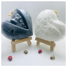 Load image into Gallery viewer, Handmade vegan soaps featuring a charcoal groom soap and a detailed bride soap. gift boxed in beautiful eco friendly packaging. crafted with natural French clays, activated charcoal and essential oils. a eco-friendly, zero waste gift that’s cruelty-free, skin-nourishing, the perfect gift for any wedding. UK Small Business