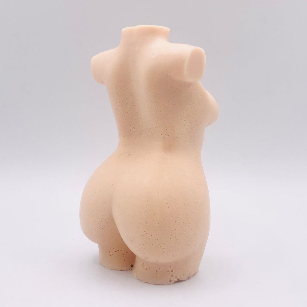 A handmade vegan soap in the shape of a curvaceous female goddess torso, featuring a detailed sculptural design, perfect for aesthetic farmhouse decor or a body-positive gift.