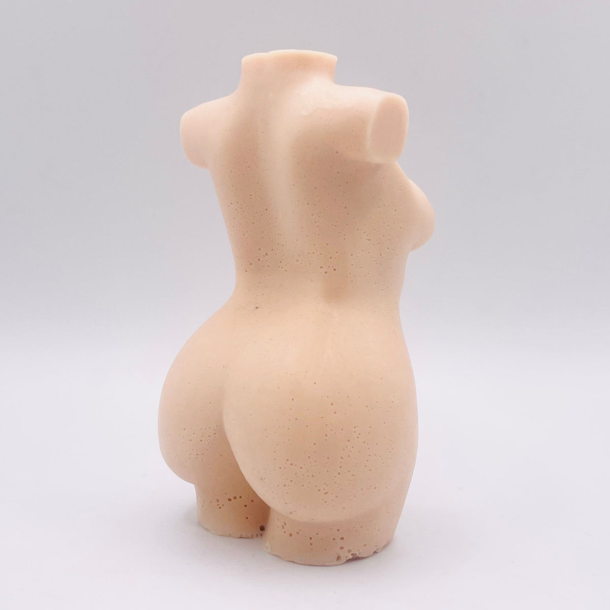 A handmade vegan soap in the shape of a curvaceous female goddess torso, featuring a detailed sculptural design, perfect for aesthetic farmhouse decor or a body-positive gift.