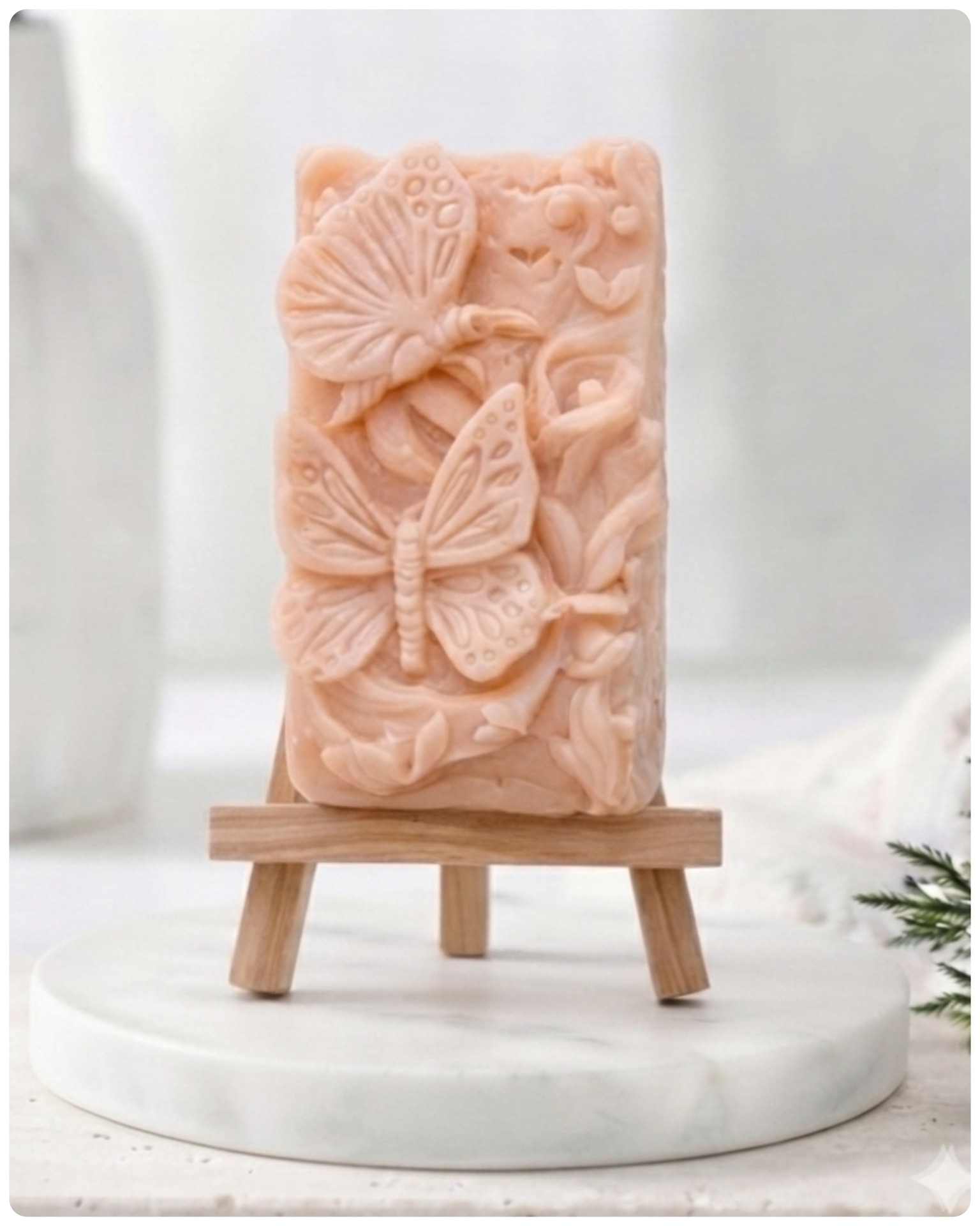 Decorative vegan soap bar with butterfly design on a wooden surface