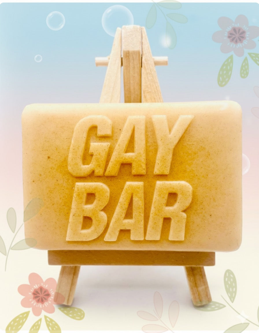 Handmade vegan soaps featuring the wording GAY BAR novelty gift. crafted with natural French clays, activated charcoal and essential oils. a eco-friendly, zero waste gift that’s cruelty-free, skin-nourishing, and perfect for pride gifts and LGBTQ gifts, hen party favours. wrapped in beautiful eco friendly packaging. 