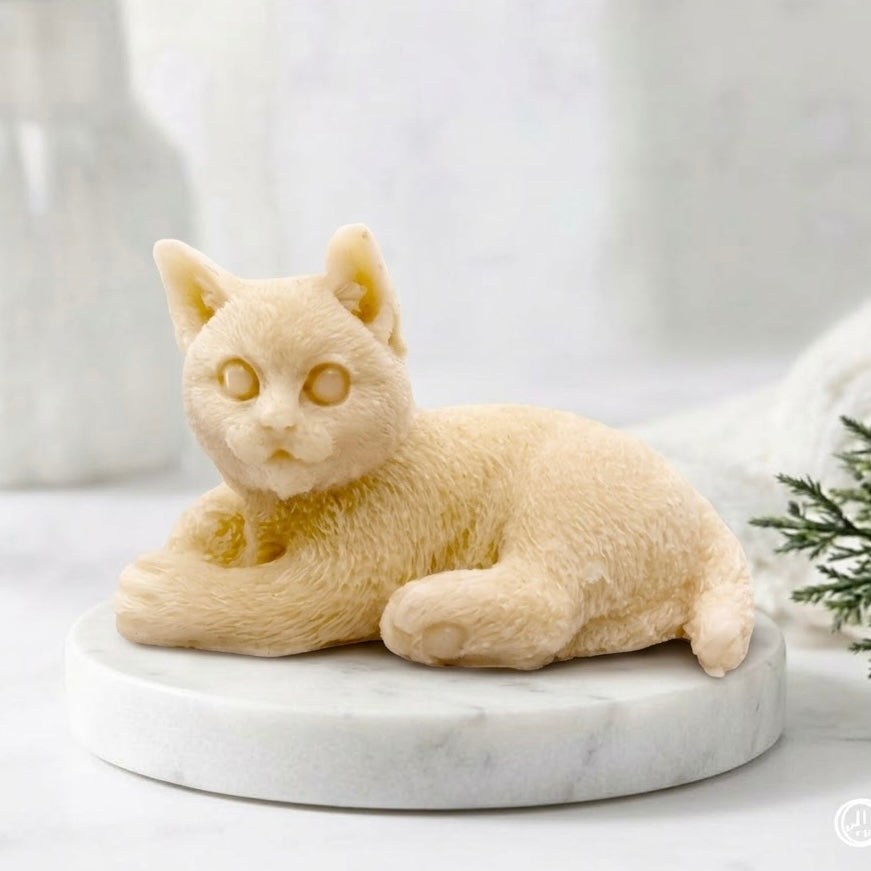 A soft yellow-coloured cat-shaped soap on a white marble stand