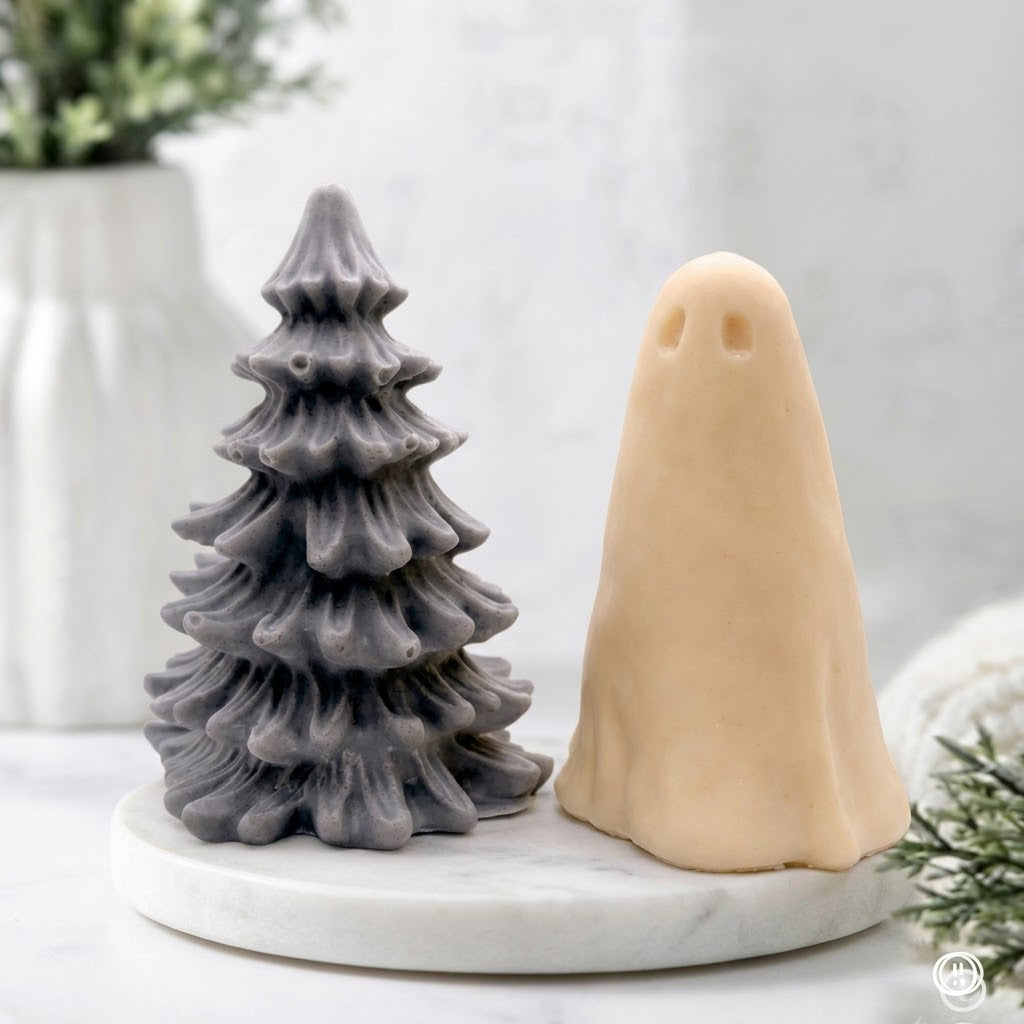 Handmade vegan soap gift set featuring a textured grey Christmas tree soap and a soft yellow ghost soap displayed together on a white marble tray.