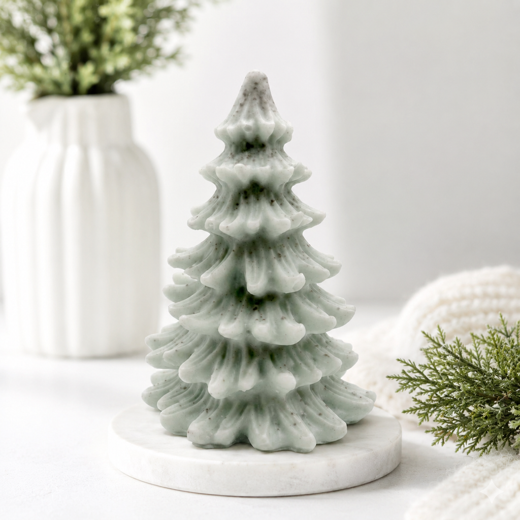 vegan soap sculpted into a realistic evergreen Christmas tree with multiple layers of textured, needle-like branches, with a subtle snow-dusted effect.