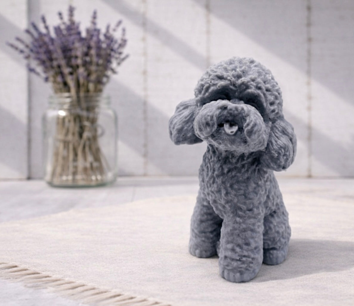 Cockapoo dog design vegan soap gift on a white surface with a vase of lavender in the background.