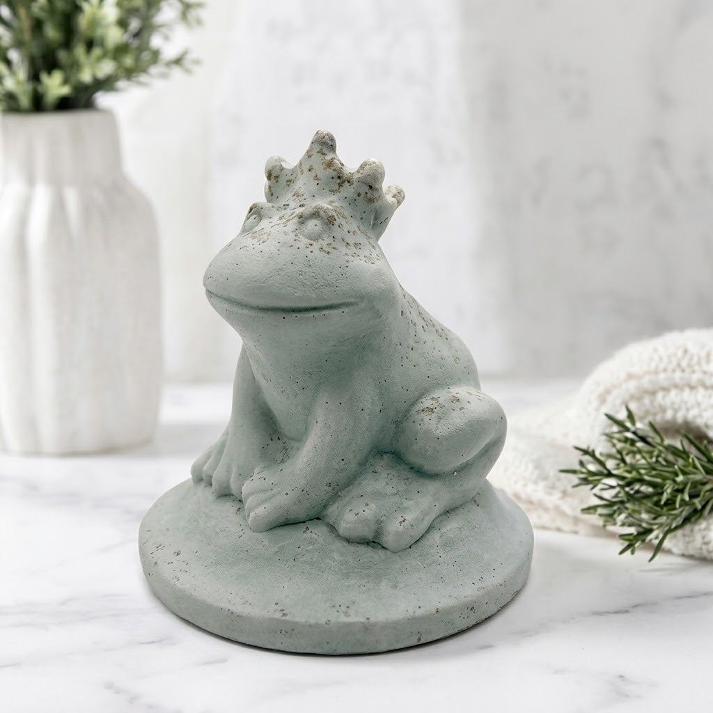 A side view of a handmade vegan soap featuring a frog prince with a crown on his head, displayed on a white background