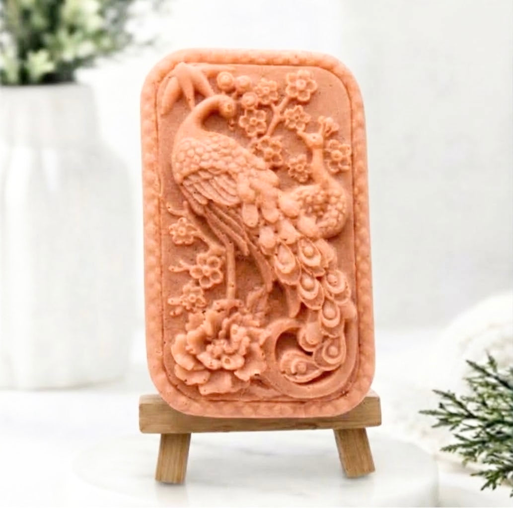 Red French clay peacock design vegan soap bar on a wooden stand in a well-lit space. Gift idea 