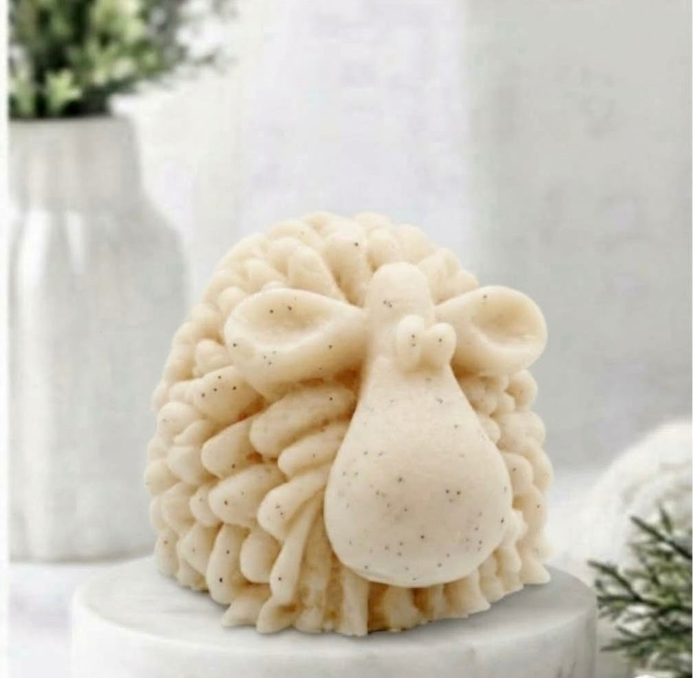 A highly detailed yellow handmade vegan soap sculpted in the shape of a fluffy sheep with thick, textured wool and a smooth face