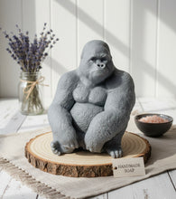Load image into Gallery viewer, A highly detailed large handmade vegan soap in the shape of a realistic sitting gorilla, featuring textured fur details, perfect for wildlife-themed farmhouse decor and unique gifts.
