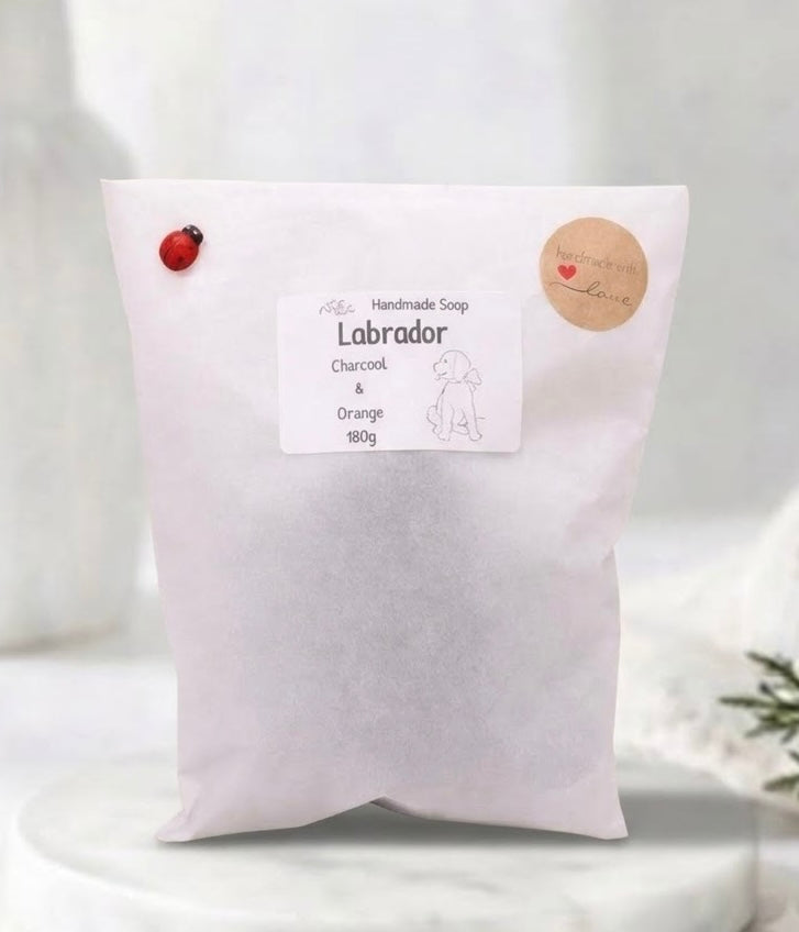 Handmade Labrador soap bar packaged in a white pouch with a printed product label, round kraft sticker, and a small ladybird accent.