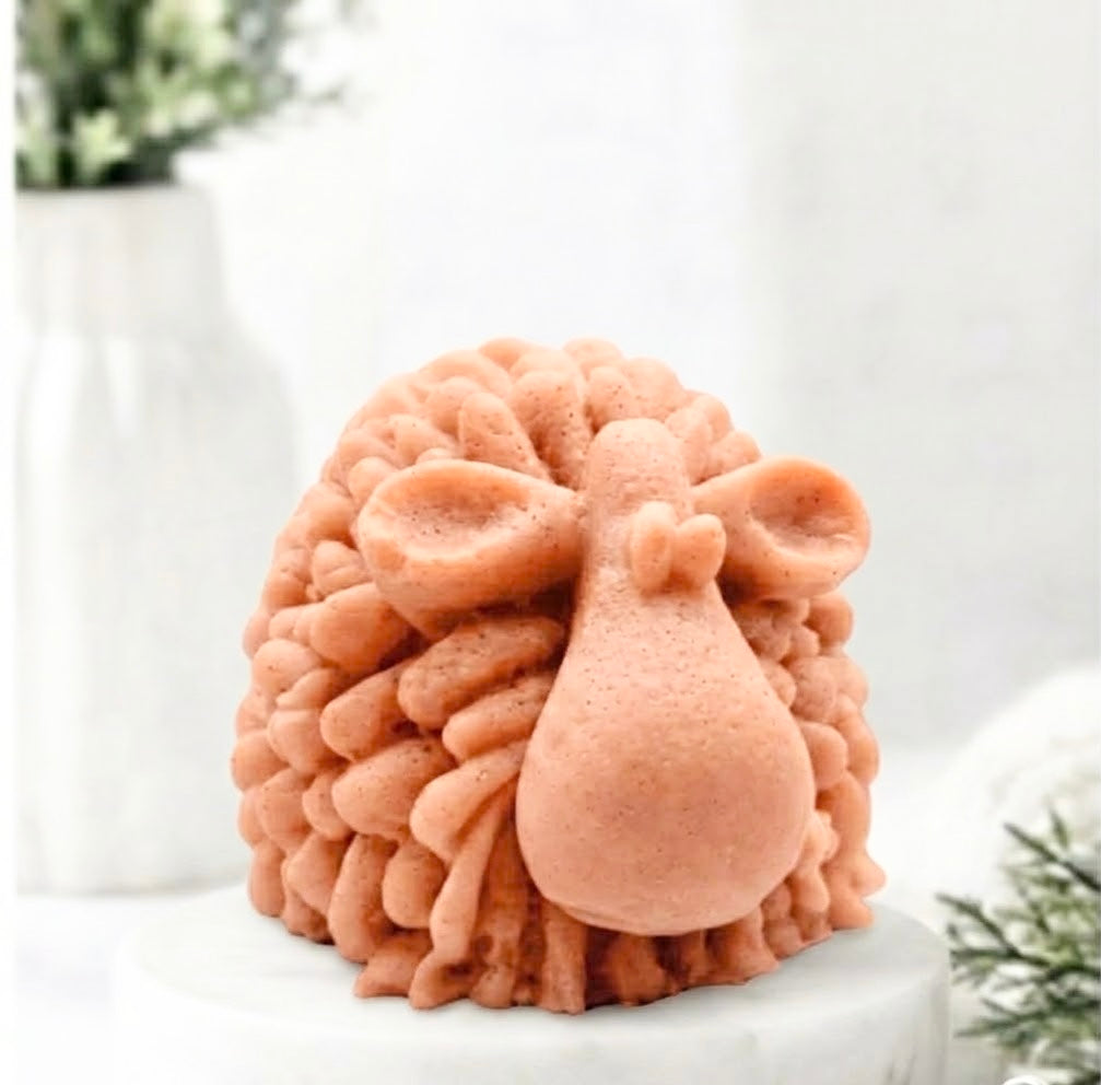 A highly detailed terracotta coloured handmade vegan soap sculpted in the shape of a fluffy sheep with thick, textured wool and a smooth face