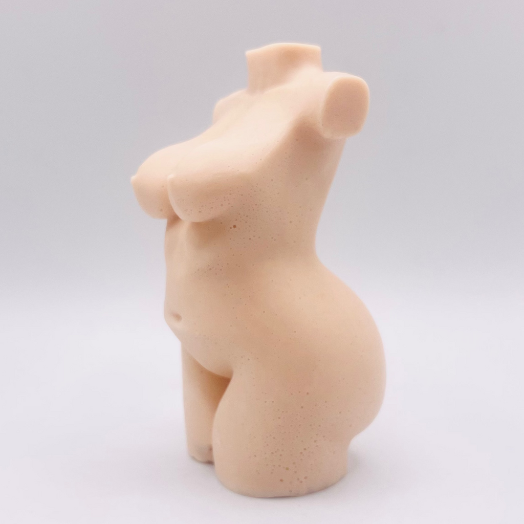 A handmade vegan soap in the shape of a curvaceous female goddess torso, featuring a detailed sculptural design, perfect for aesthetic farmhouse decor or a body-positive gift.