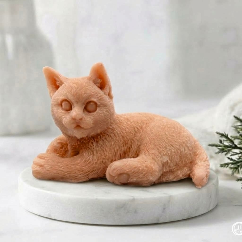 A terracotta coloured cat-shaped soap on a white marble stand