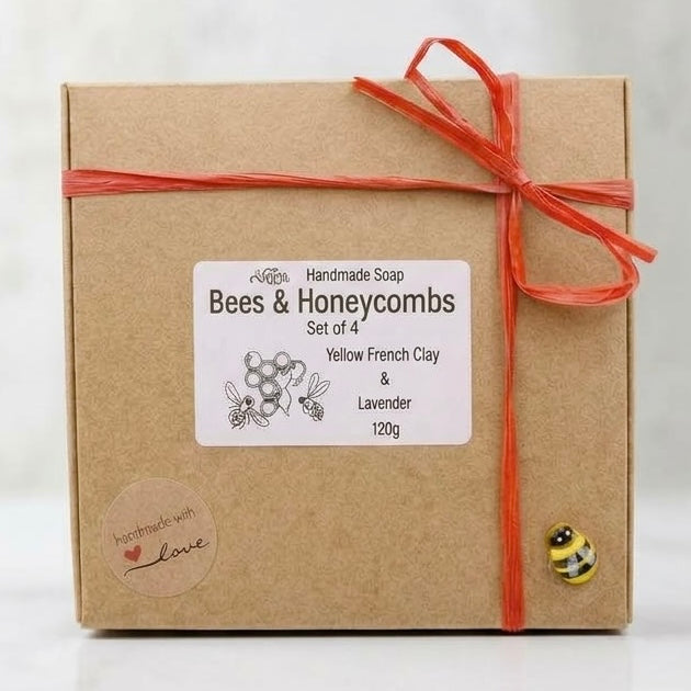 Kraft paper box with a red ribbon and 'Bees & Honeycombs' label on a wooden surface.
