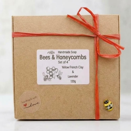 Kraft paper box with a red ribbon and 'Bees & Honeycombs' label on a wooden surface.