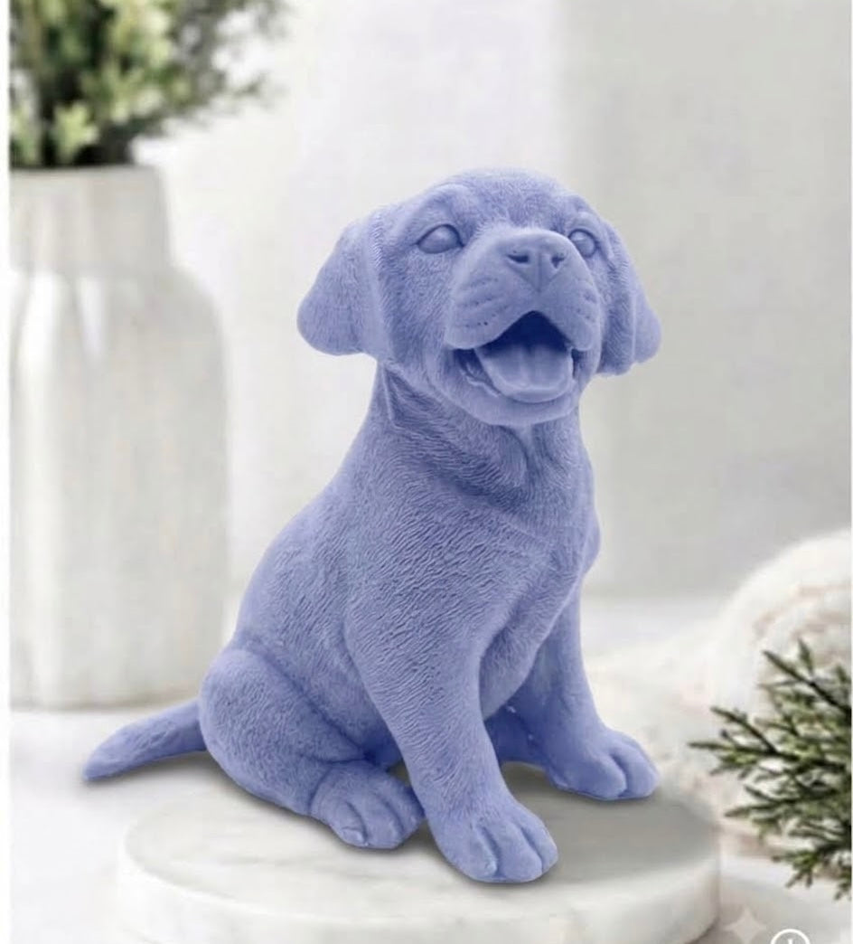 Handmade Labrador puppy soap bar in a soft indigo blue hue, sitting upright and looking slightly upwards with an open-mouthed expression.