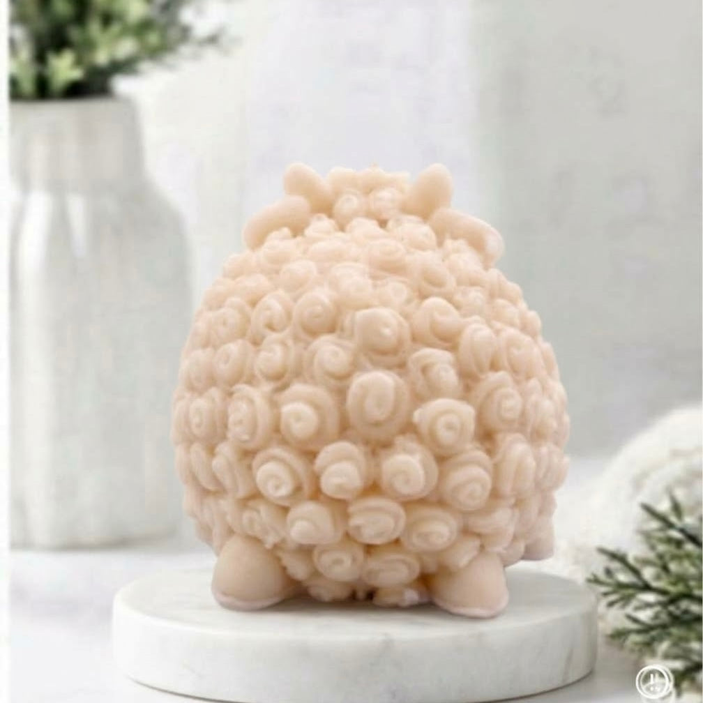 A soft yellow sheep rear view of a sheep / Ram soap with curly textured wool, closed eyes, and a smiling face, displayed on a white surface against a soft blurred background.