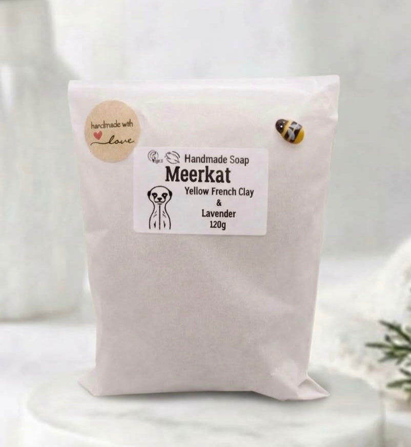 Plastic-free paper packaging for handmade vegan meerkat soap with product label and bee embellishment.