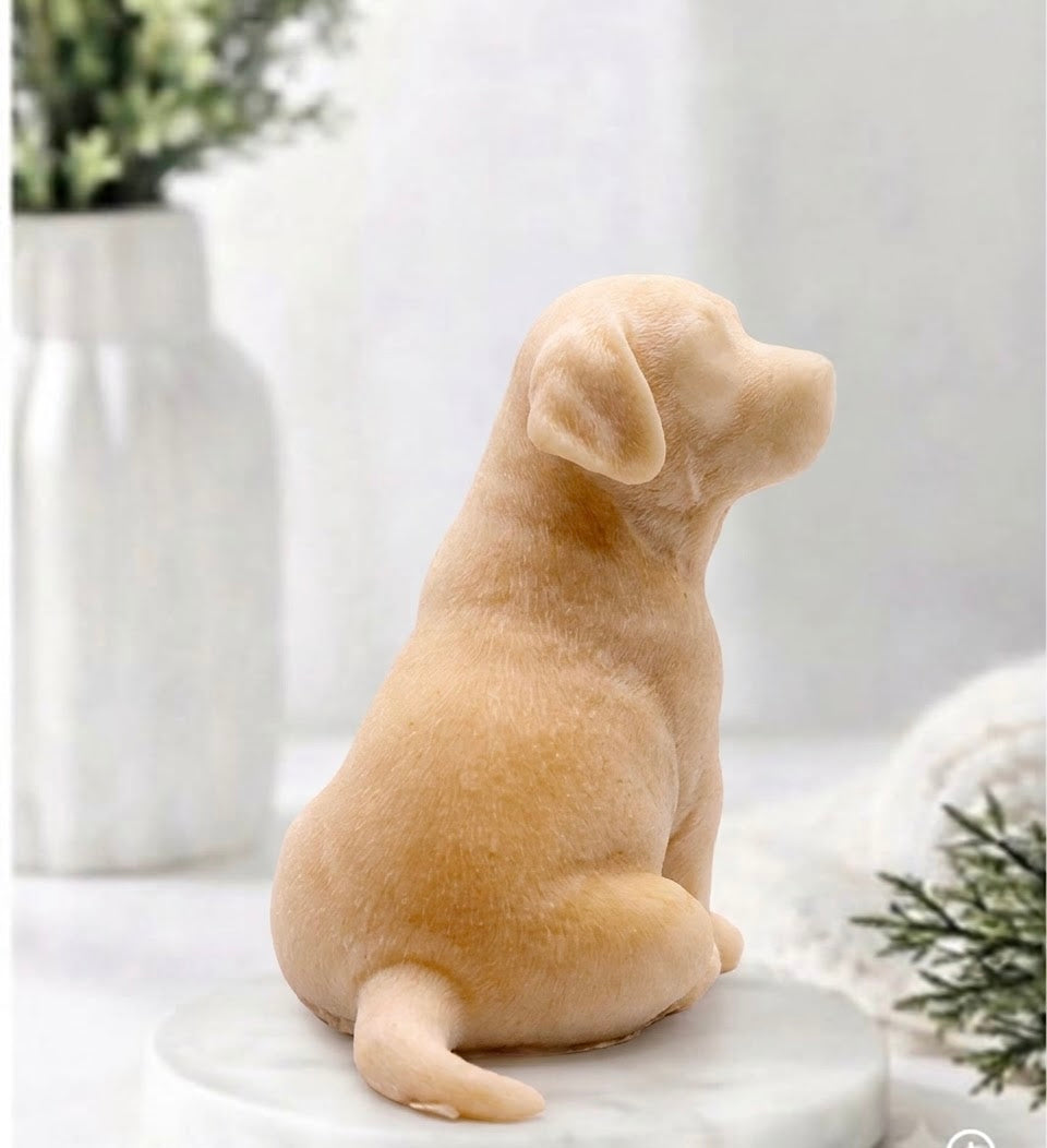 Rear-side profile view of a warm golden yellow French clay handmade Labrador puppy dog vegan soap bar, showing the tail and textured coat detail.