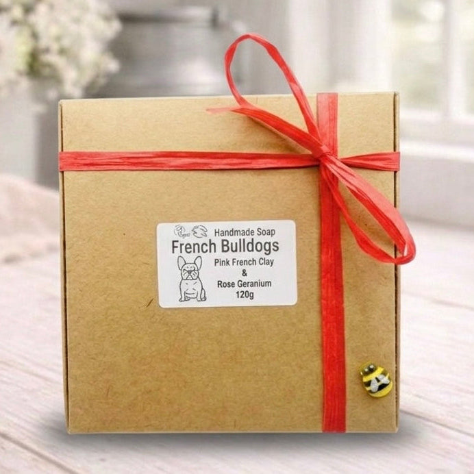 Gift box with a red ribbon on a wooden surface with a blurred background