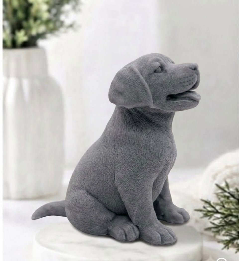 Side profile of a handmade activated charcoal Labrador puppy dog vegan soap bar sitting upright on a white round tray, featuring a detailed coat texture, floppy ears, and open mouth.