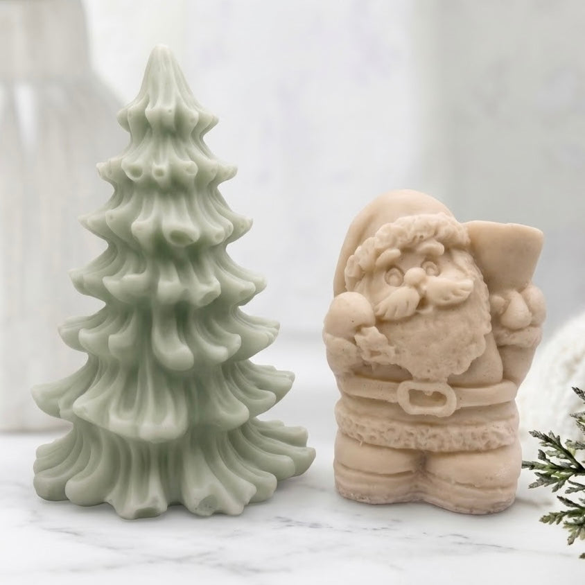 Handmade Santa and Christmas Tree soap gift set featuring a green pine tree and cream-colored Santa figurine. Perfect for holiday gifting.