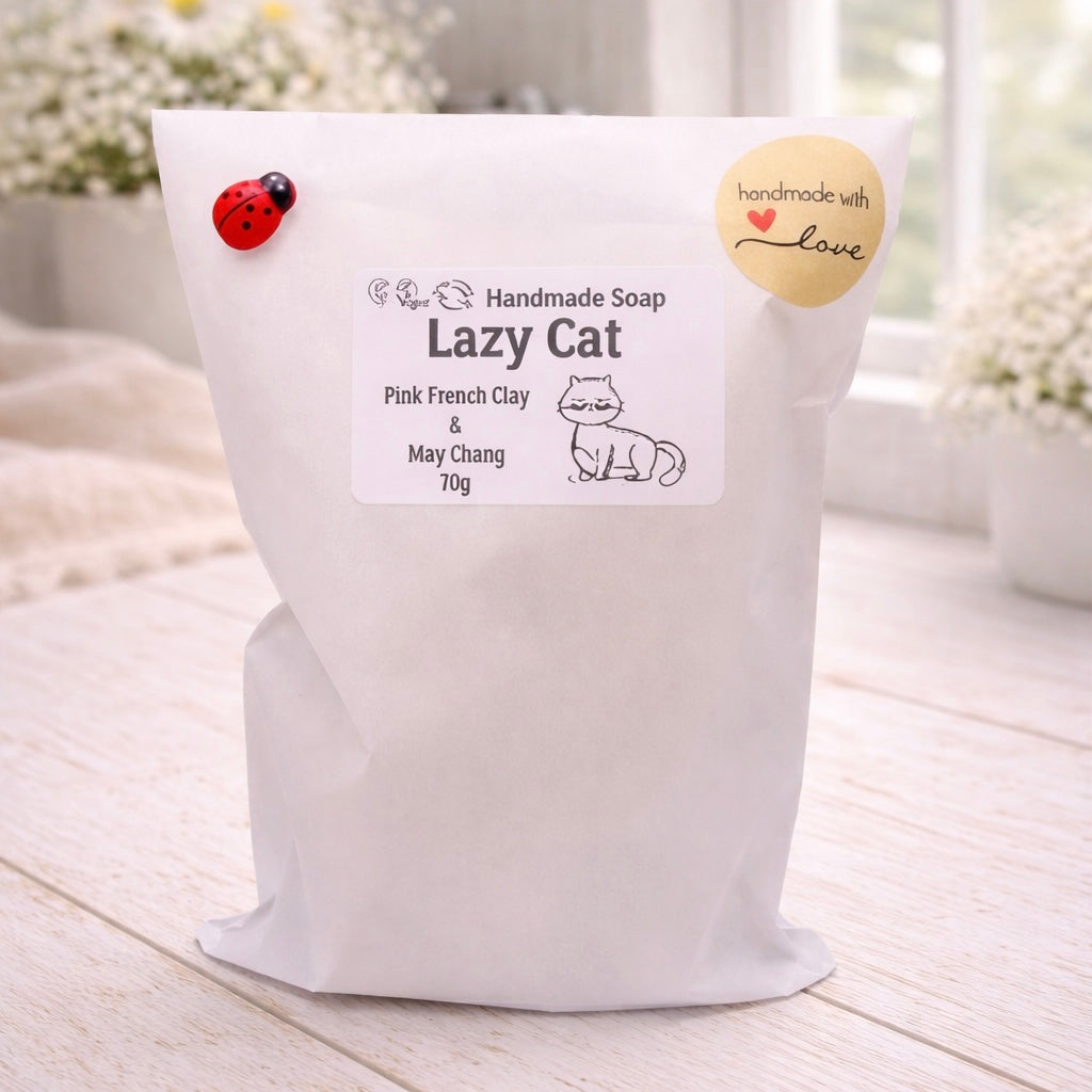 White bag of 'Lazy Cat' handmade soap with a label on a light wooden surface.