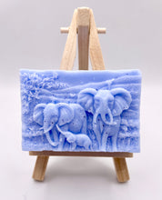 Load image into Gallery viewer, Handmade vegan soap featuring an elephant family with baby elephant and packed in beautiful eco friendly packaging. crafted with natural French clays, activated charcoal and essential oils. a eco-friendly, zero waste gift that’s cruelty-free, skin-nourishing, and perfect for elephant lovers or animal themed gifts. Small business UK
