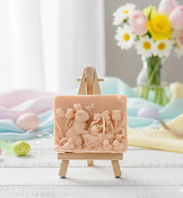 Load image into Gallery viewer, Intricate handmade soap scene from Soap Simple Creations featuring an Easter bunny, chicks, and tulips, displayed on a wooden easel with spring flowers. Vegan and cruelty free soap. 
