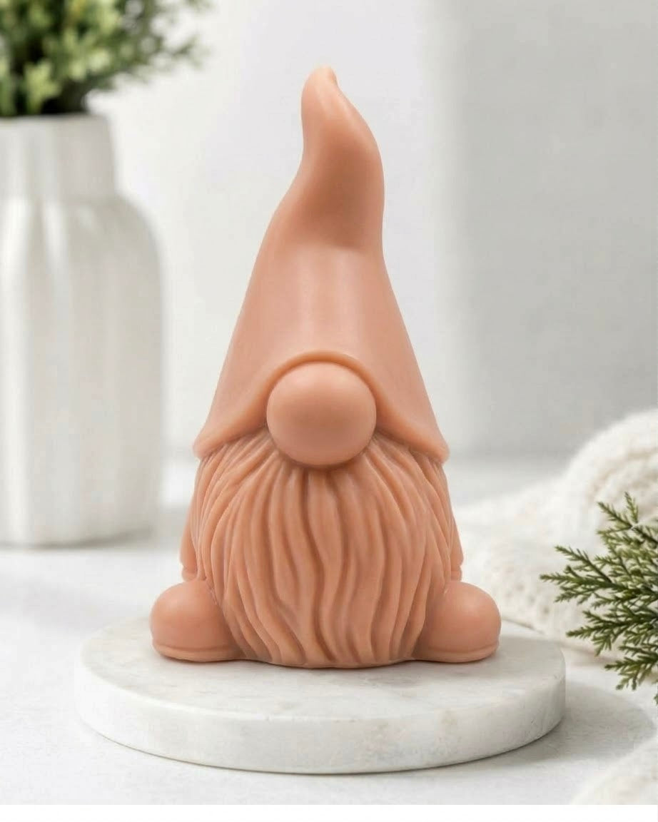 Front view of a textured artisanal gnome vegan soap bar on a marble plinth.