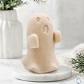 A soft yellow ghost soap gift on a marble base.