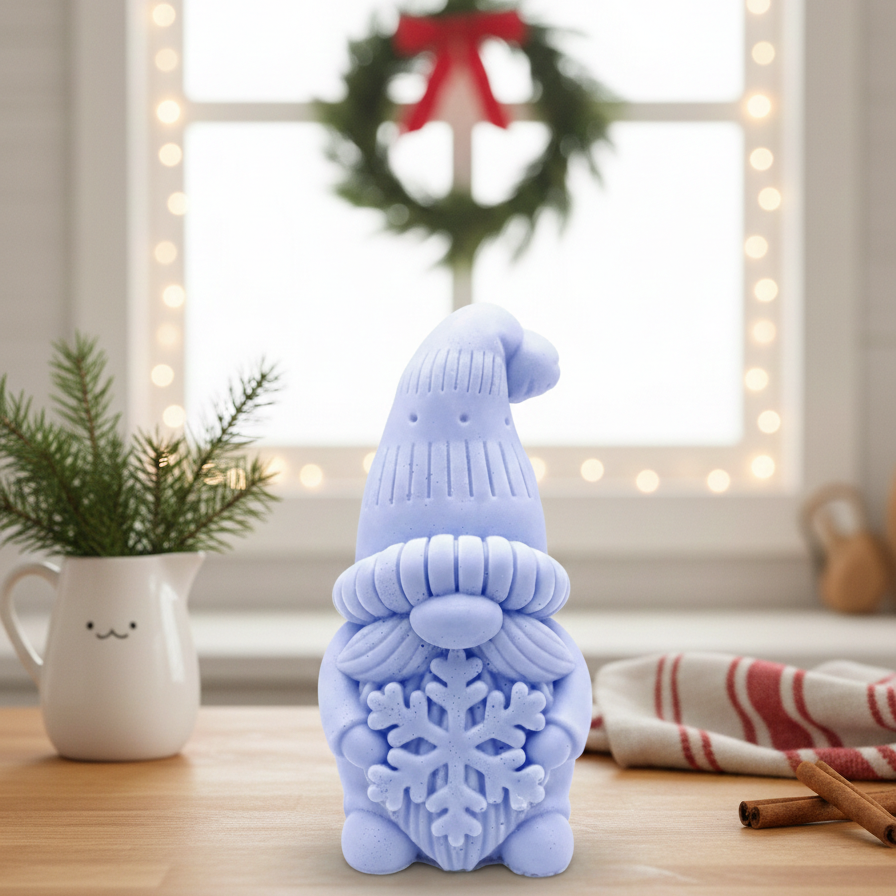 Handmade vegan soaps featuring a christmas gnome holding a snowflake in beautiful eco friendly packaging crafted with natural French clays, activated charcoal and essential oils. 