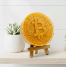 Load image into Gallery viewer, Golden Bitcoin-shaped vegan soap on a wooden stand with a white background
