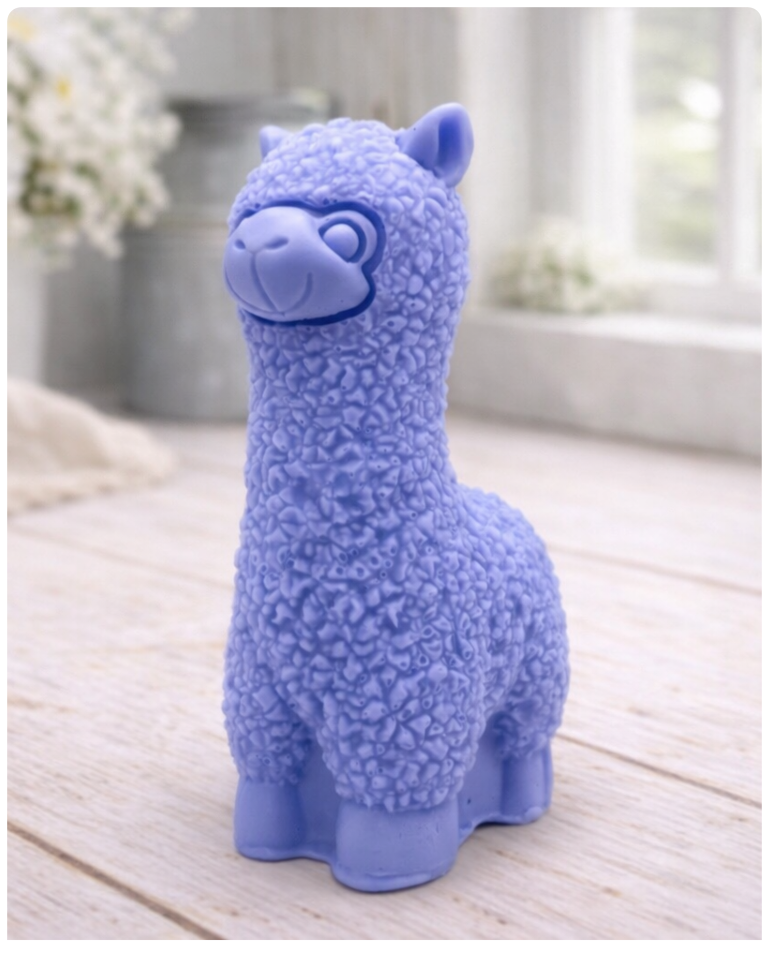 handmade vegan soap in the shape of a realistic standing alpaca sculpture, featuring detailed curly wool texture and a smiling face, displayed on a rustic white wooden surface in a bright farmhouse decor setting.