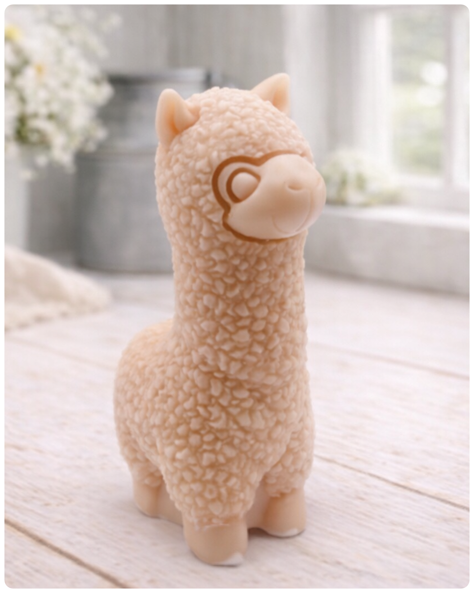 handmade vegan soap in the shape of a realistic standing alpaca sculpture, featuring detailed curly wool texture and a smiling face, displayed on a rustic white wooden surface in a bright farmhouse decor setting.
