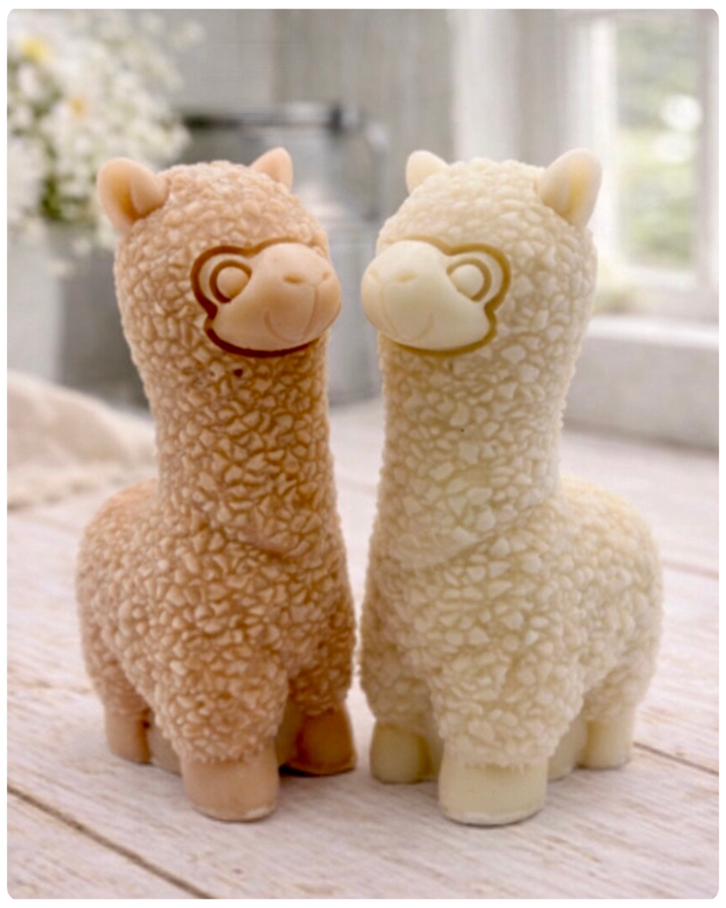 handmade vegan soap in the shape of a realistic standing alpaca sculpture, featuring detailed curly wool texture and a smiling face, displayed on a rustic white wooden surface in a bright farmhouse decor setting.