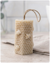 Load image into Gallery viewer, A tall, rectangular handmade vegan soap with a detailed honeycomb texture on all sides and small embossed bees, featuring a natural twine hanging rope, displayed upright on a light wooden surface.
