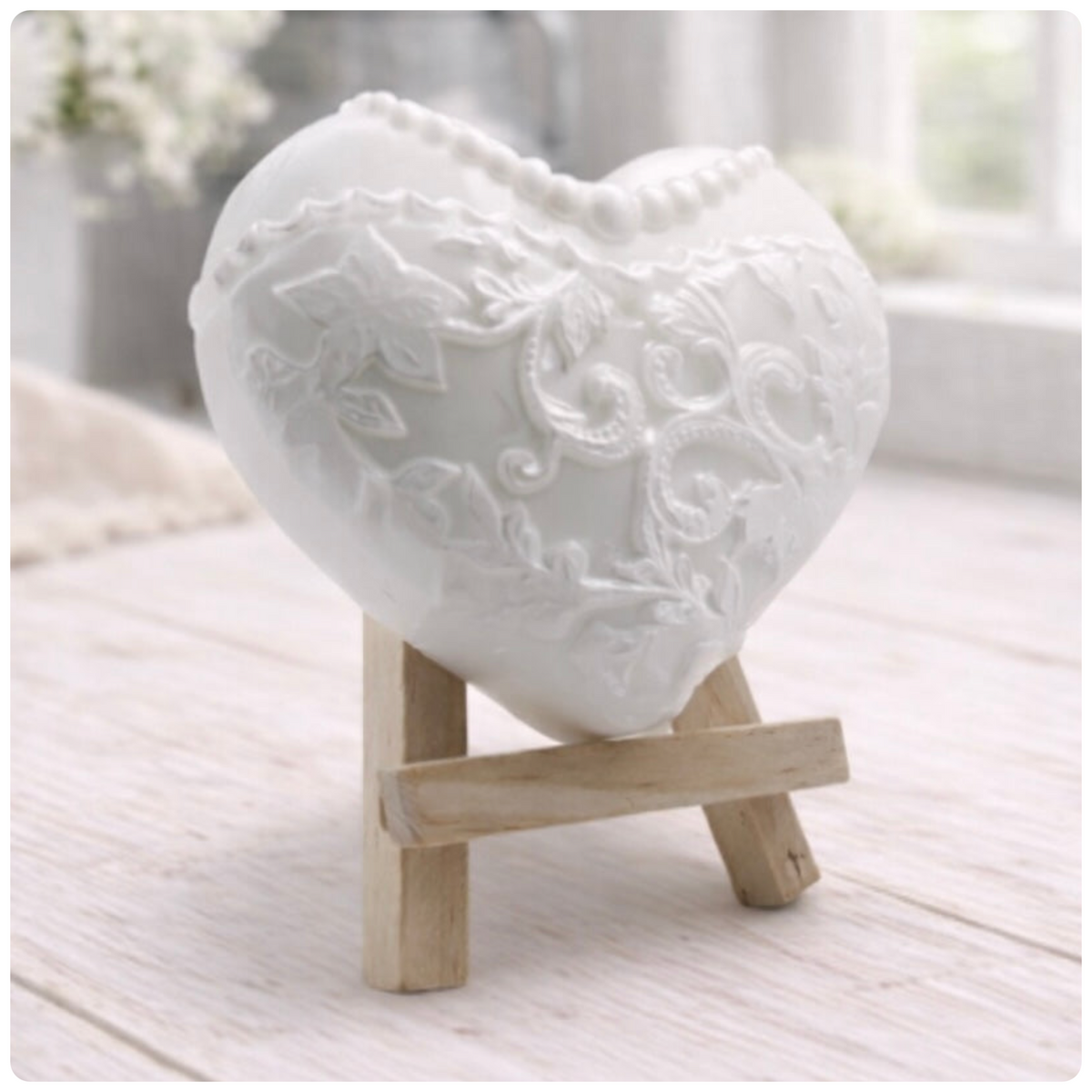 A heart-shaped wedding soap shaped like a bride's white lace dress, displayed on small wooden easels. Gift boxed ready to give. 