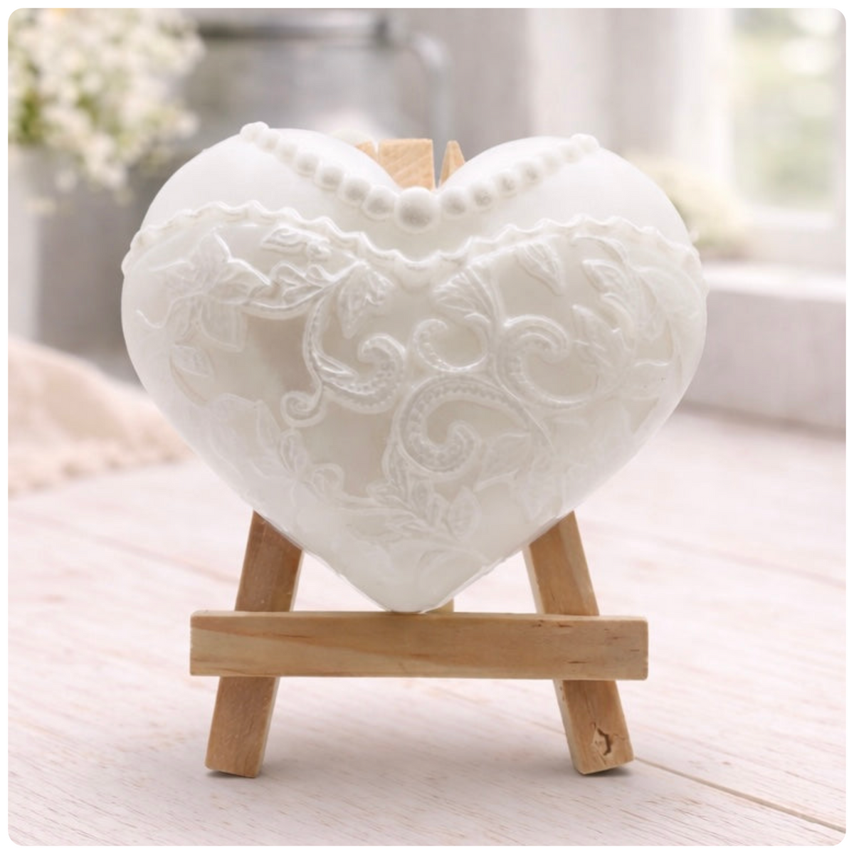 A heart-shaped wedding soap shaped like a bride's white lace dress, displayed on small wooden easels. Gift boxed ready to give. 