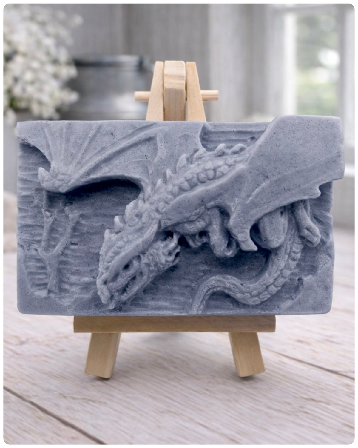 handmade vegan soap gift featuring a detailed relief of a skull wearing a crown, surrounded by a border of roses, displayed on a small wooden easel.