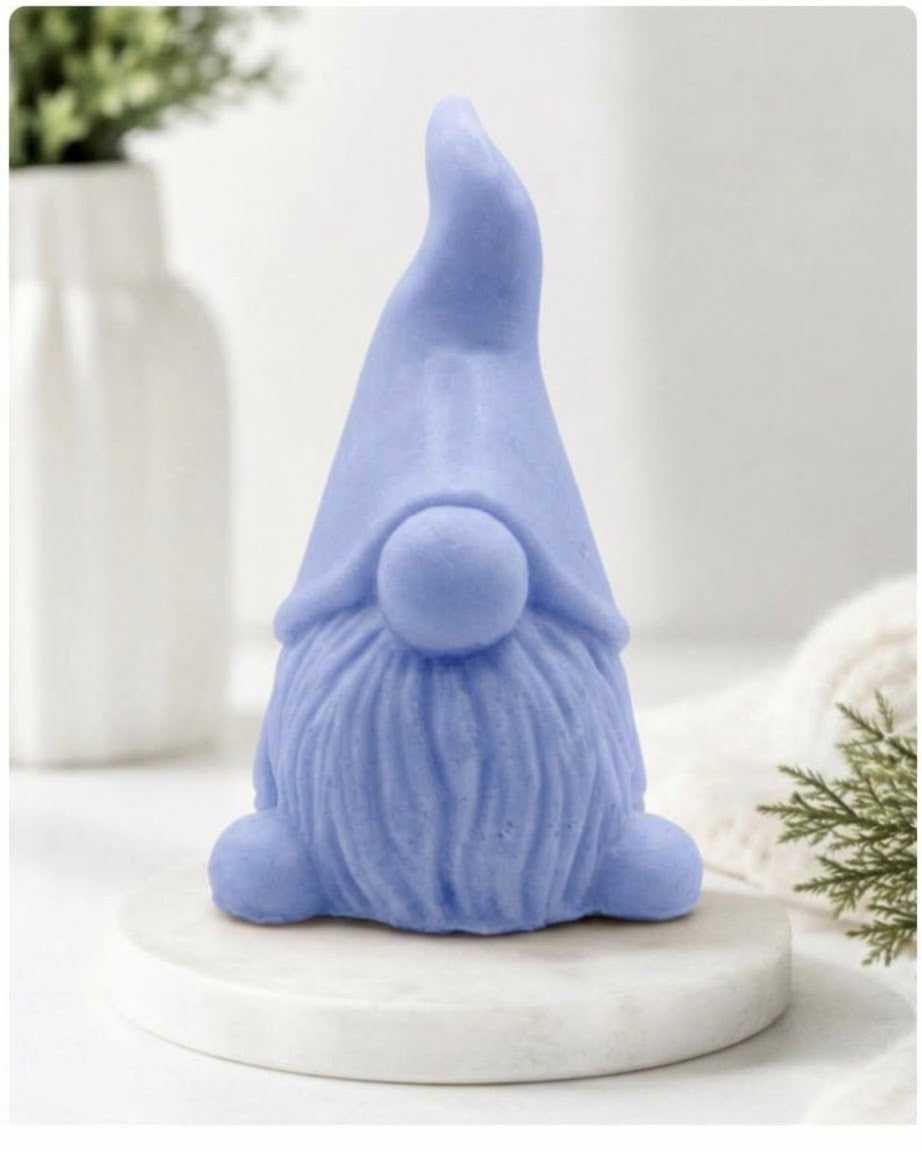 Front view of a pastel blue artisanal gnome vegan soap figure on a marble base.
