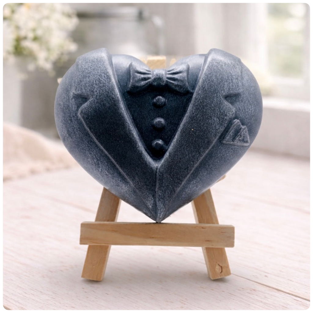 A pair of heart-shaped wedding soaps shaped like a groom's grey tuxedo, displayed on small wooden easels. Gift boxed ready to give. 