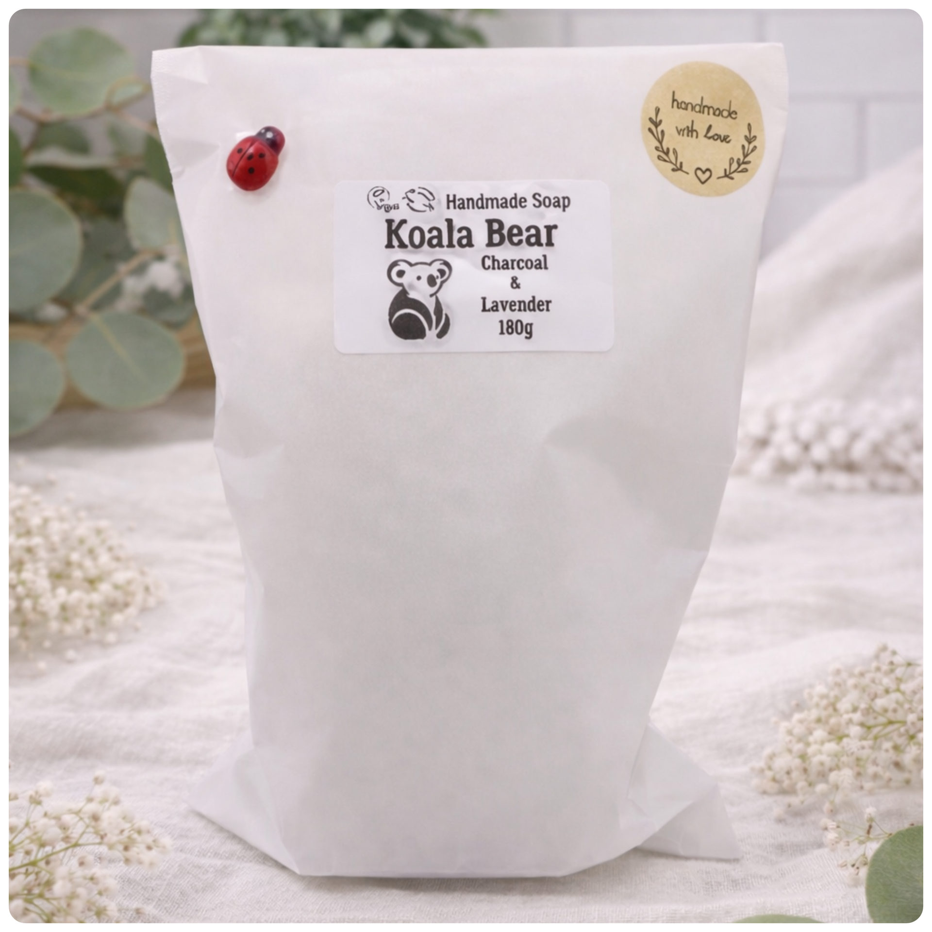 White bag of handmade soap labeled 'Koala Bear' with a natural background