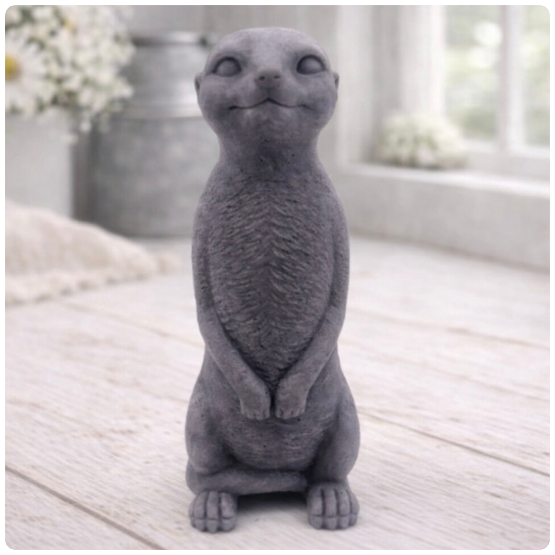 A highly detailed handmade vegan soap, sculpted in the shape of a realistic meerkat standing upright in its iconic sentinel pose, featuring textured fur and a curious facial expression, displayed on a light wooden surface.