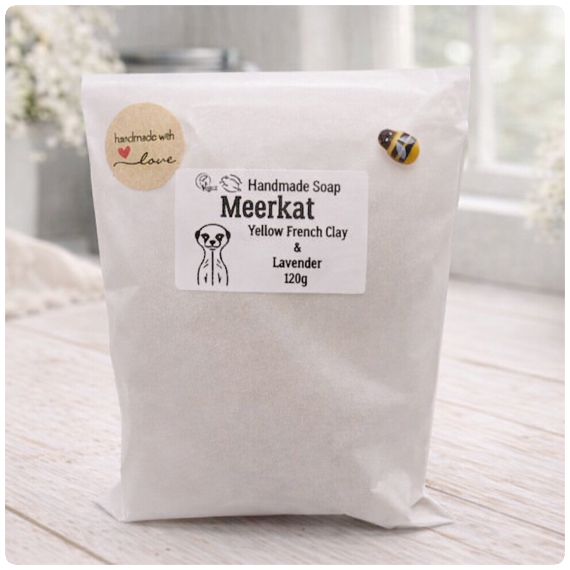 Handmade soap package with a label on a light wooden surface