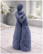 Load image into Gallery viewer, handmade vegan soap, sculpted as a mother and daughter in a tender standing embrace, featuring an intricate embossed floral and vine pattern on their dresses.

